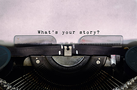 A typewriter showing typed text 'What's your story?'