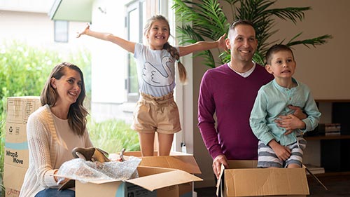 Mum, dad, a young son and a daughter enjoy unpacking